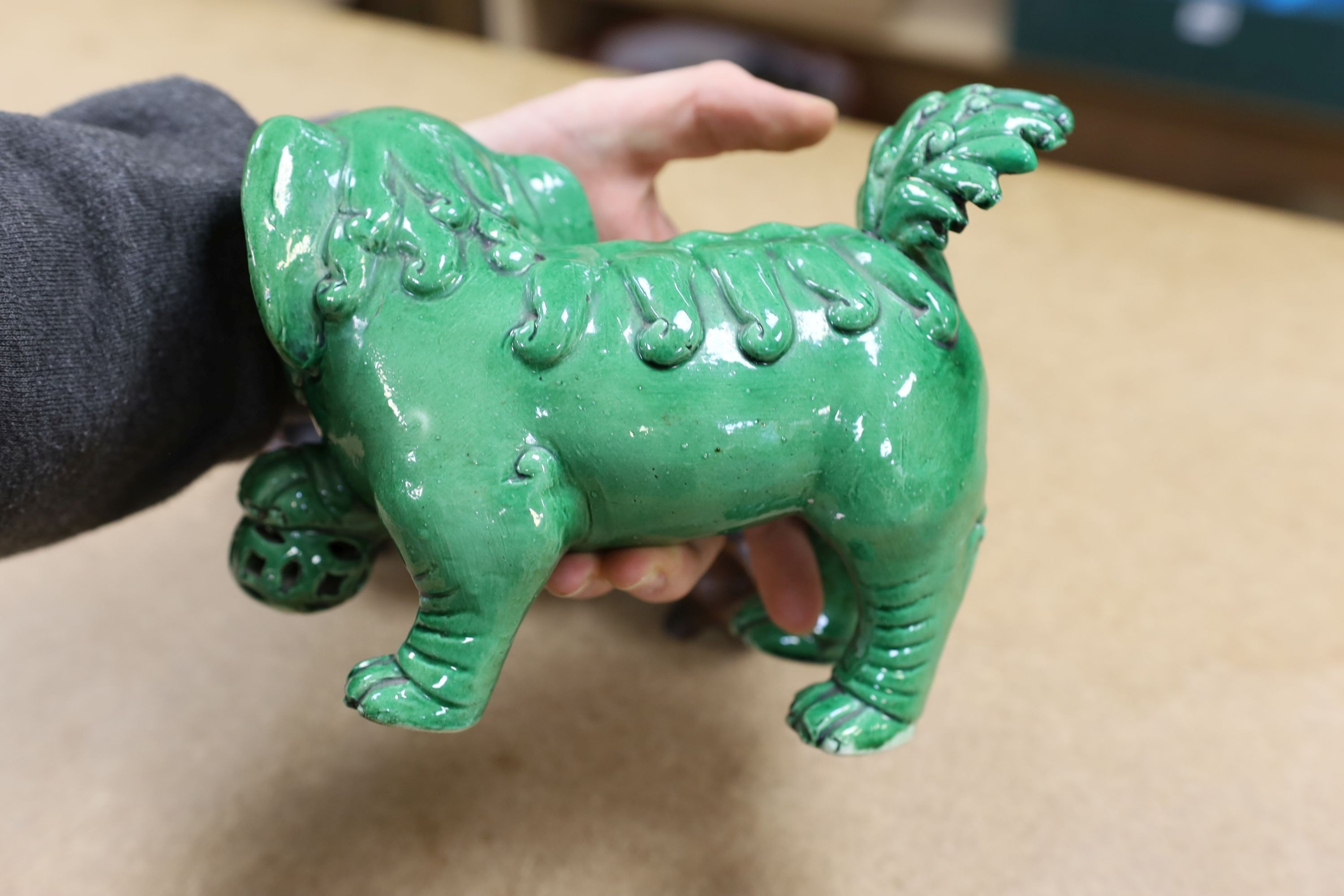 A 19th century Chinese green glazed model of a lion-dog, and two green crackle glaze jars, tallest 16cm